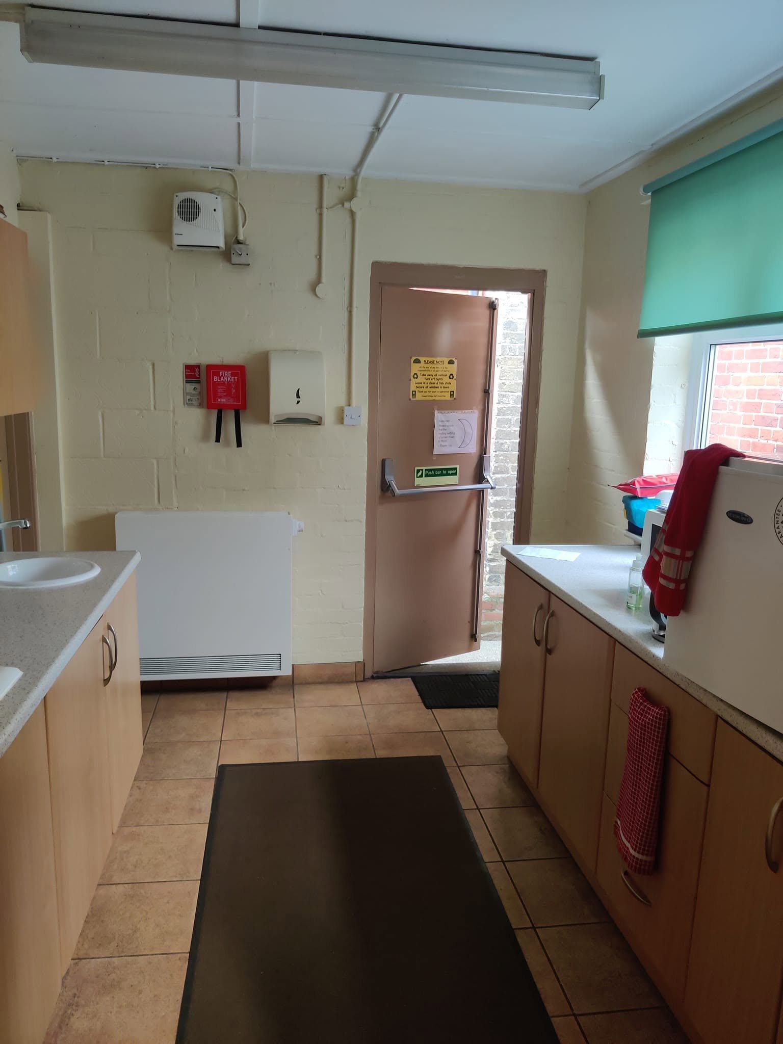 The village hall kitchen with worktops, cupboards and a sink