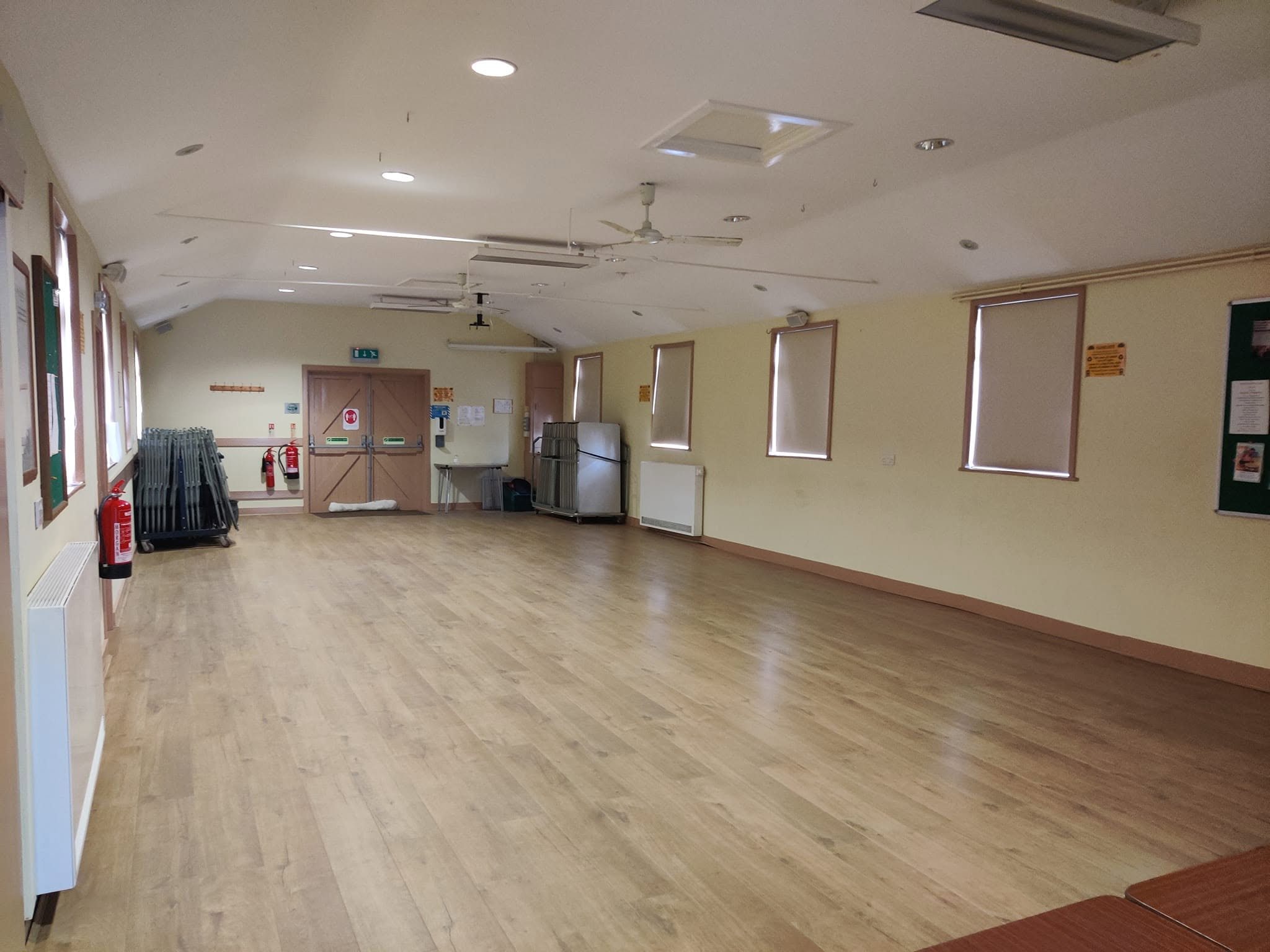 The spacious main hall with tables and chairs stored to one side